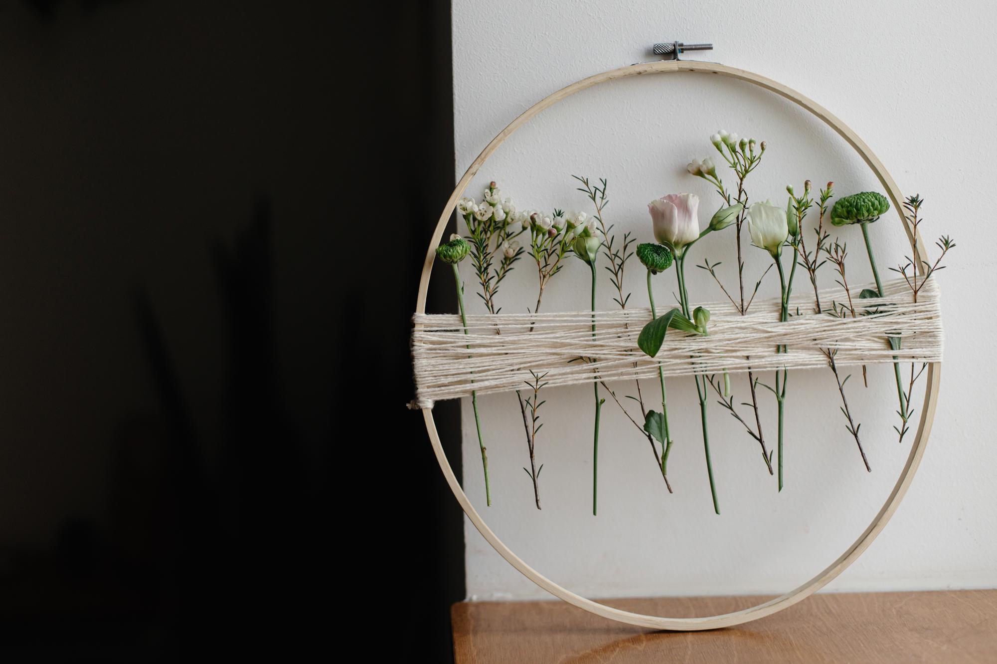 studio wall with framed small embroidered panels
