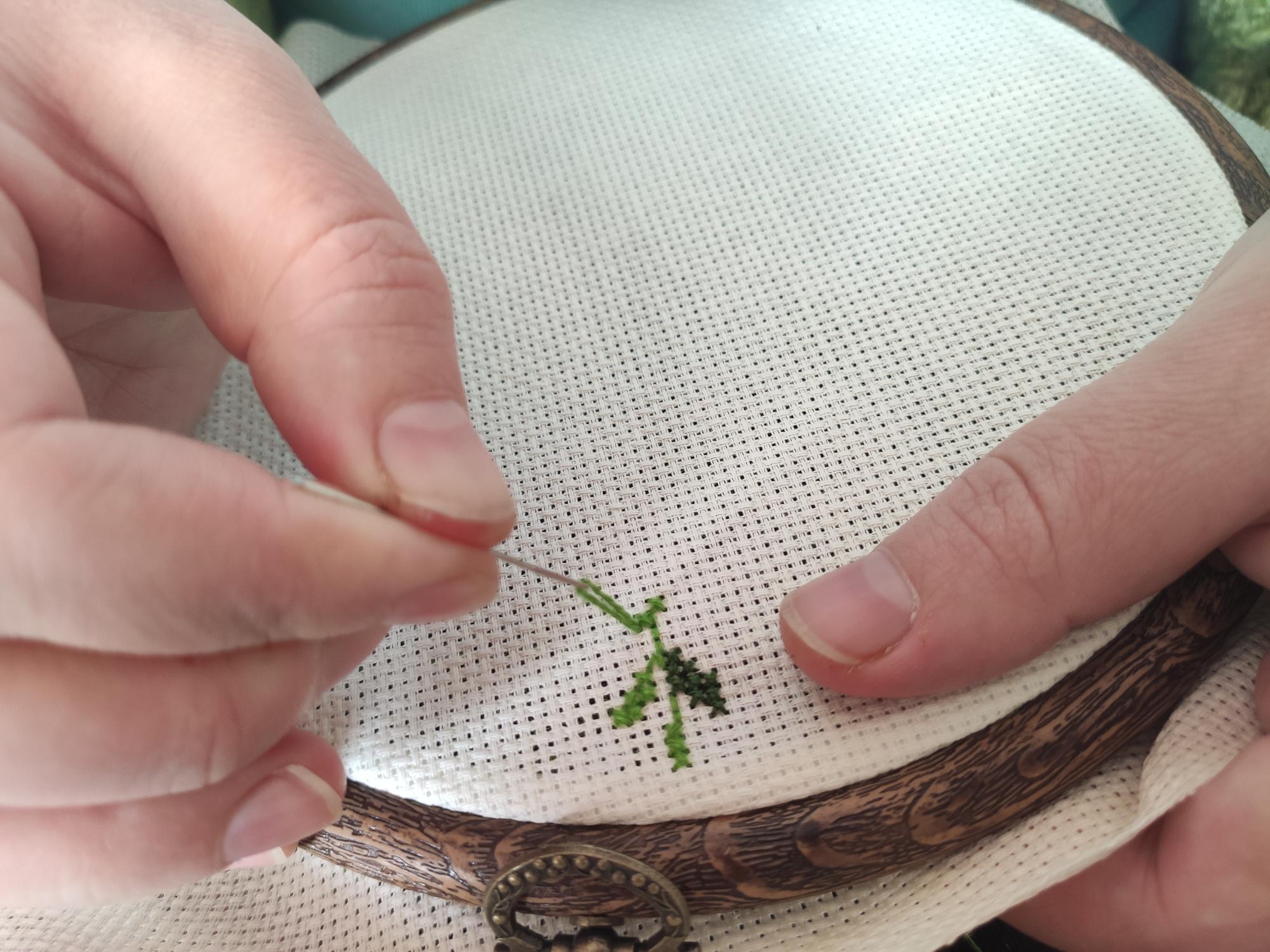 close-up of hand embroidery on linen with neutral threads